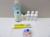 a toothbrush, toothpaste, toothpaste, and toothpaste on a table