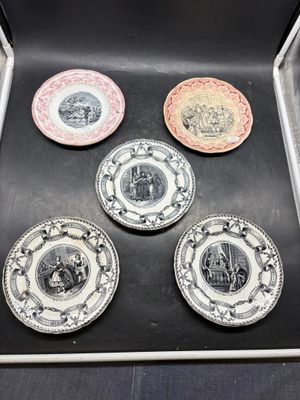 four plates in a box with a picture of a castle and a castle on them