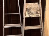 two ladders sitting next to each other on the floor