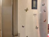 an image of a refrigerator with butterflies on the door
