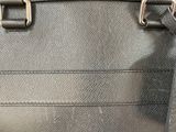 a close up of a purse with a tag on it
