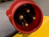 a close up of a red electrical plug on a yellow box
