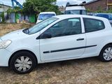 a picture of a small white car parked in a lot