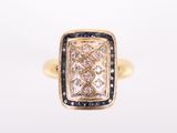 a close up of a gold ring with a blue and white diamond
