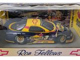 the box is open to show a toy car in it ' s packaging