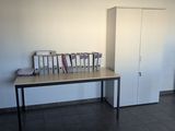 a table with a bunch of books on it in a room