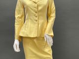 an image of a mannequin dressed in a yellow suit and skirt