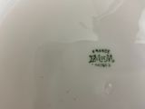 a close up of a white plate with a horse on it