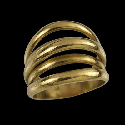 a close up of a gold ring on a black background