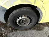 a close up of a tire on a yellow car