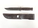 pair of knives on a white surface with a small knife in the middle