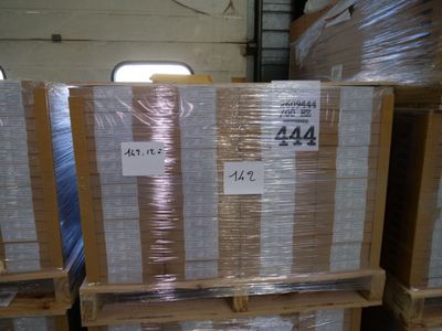 several pallets of boxes are stacked on pallets in a warehouse