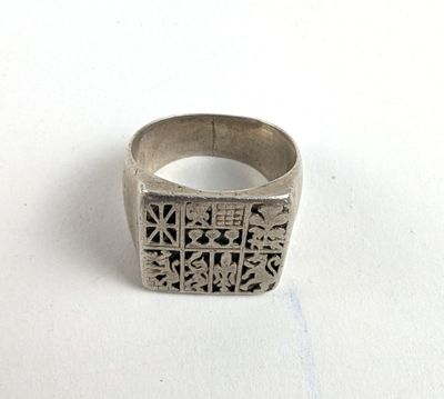 an image of a silver ring with a design on it
