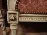 a close up of a chair with a red upholstered seat
