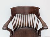 a wooden chair that has a wooden seat on it