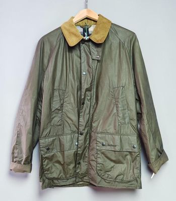 a green jacket hanging on a hanger on a wall