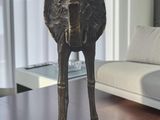 a statue of an elephant on a table in a living room