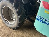 a tractor that is parked in the dirt