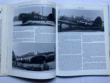 a book with pictures of airplanes in it on a table