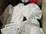 a box full of clothes that is sitting on the floor