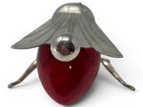 a red apple with wings on it sitting on a white surface