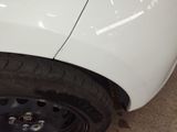 a close up of a tire on a white car