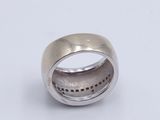 a close up of a silver ring on a white surface