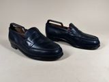 a pair of men ' s black loafers on a white background
