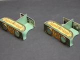 pair of green and gold bookends with a picture of a piano