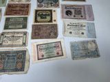 some old paper money sitting on top of a white table