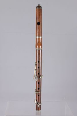a close up of a wooden flute on a clear surface