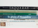 many books stacked on top of each other on a table