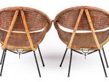 pair of wicker chairs with metal legs on a white background