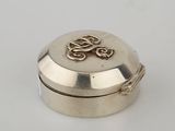 an image of a small silver box with a dragon on it