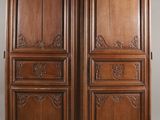 two wooden doors with carvings on the sides of them