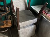 a chair that is sitting next to a chair in a room