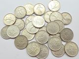 a pile of silver coins on a white surface