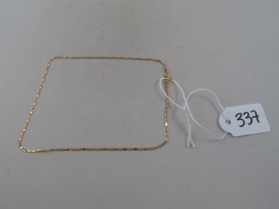 a close up of a gold chain with a price tag on it