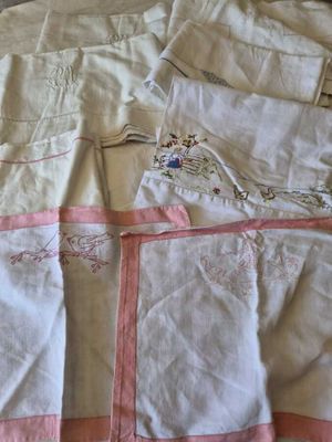 a bed with a white and pink comforter on it