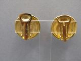 pair of gold plated cufflinks with wooden handles on clear acrylic stand
