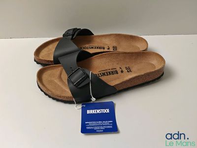 new birkett black sandals with a tag on the bottom