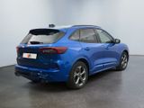 the rear end of a blue car in a showroom