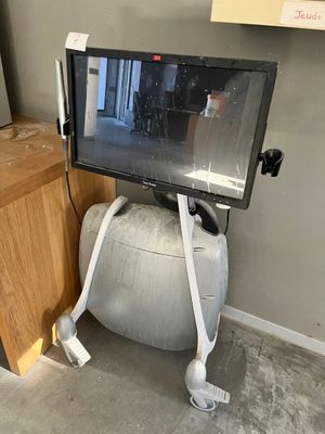 a television that is sitting on top of an exercise ball