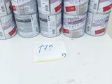several cans of paint sitting on top of a table next to a sign