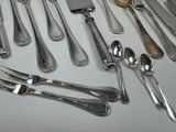 a lot of silverware on a table with a knife and fork