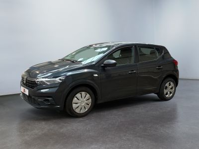a black car is parked in a room with a white wall