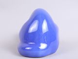 a blue vase that is sitting on a white surface