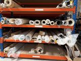 many rolls of paper on the shelves in the warehouse