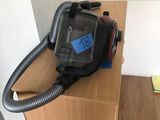 a vacuum that is sitting on top of a wooden table