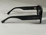 a close up of a pair of black sunglasses on a white surface